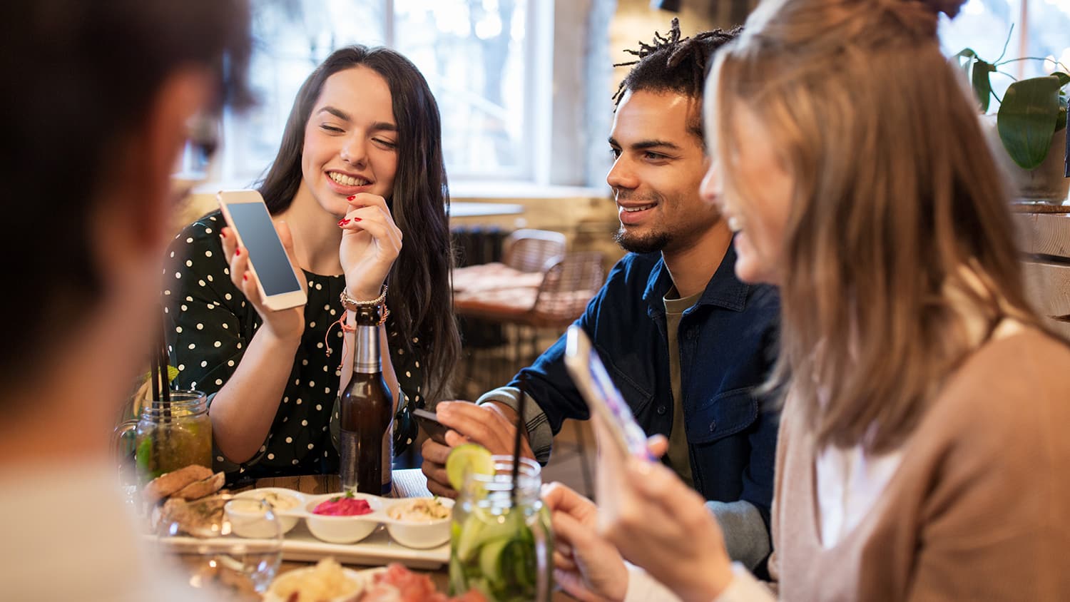 Friends smiling and having fun together at a meal