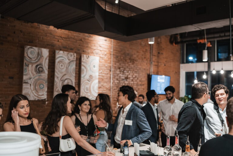 A crowd of adults at a social event at SOVA Micro Room and Social Hotel.